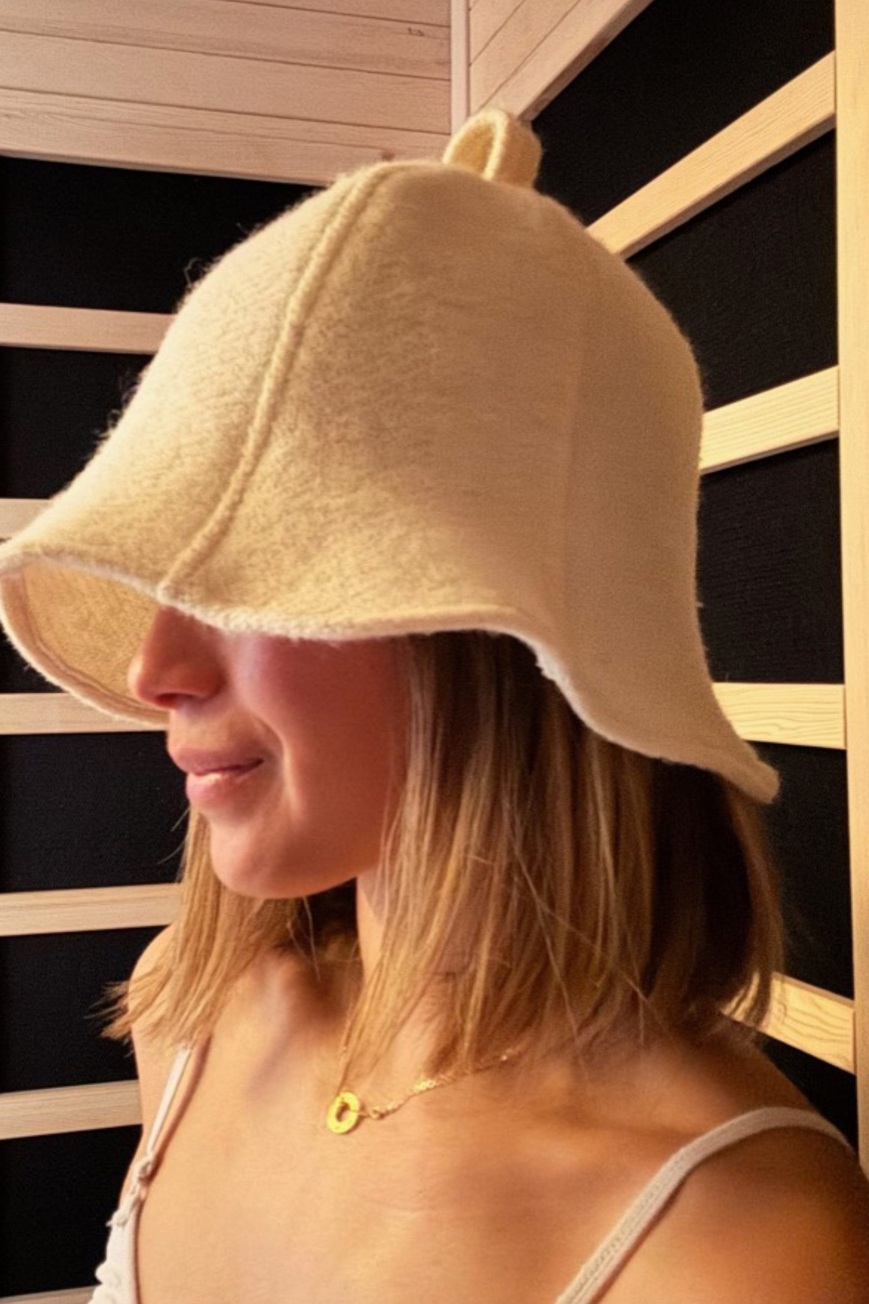 Model wearing Pure Canadian wool sauna hat in undyed natural wool